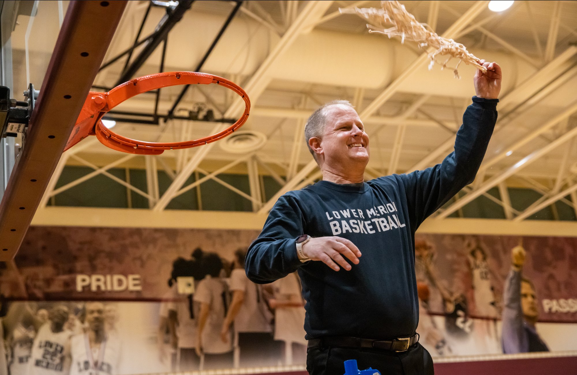 Coach Downer cutting down the net